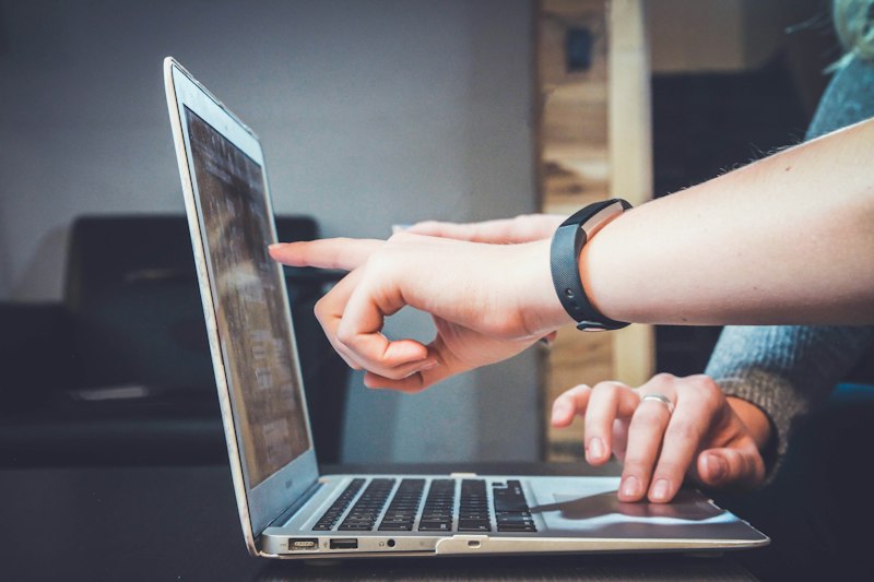 Person resizing images on laptop for email campaign